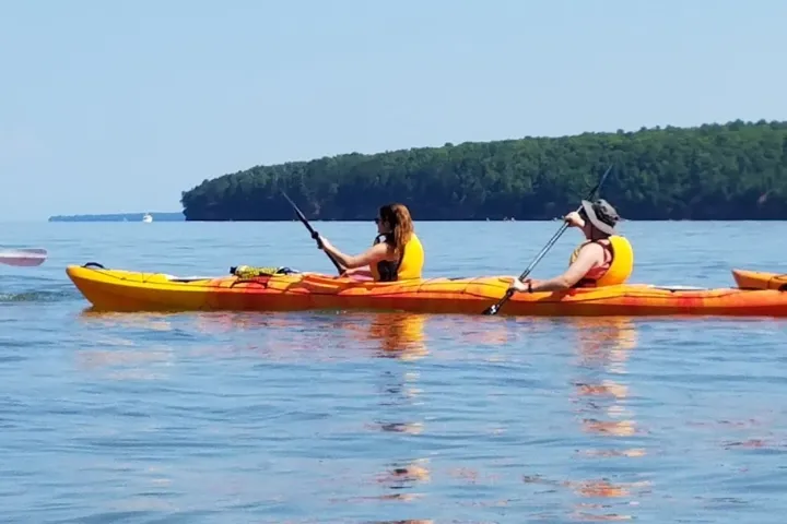 People kayaking in open water at Meyers Beach