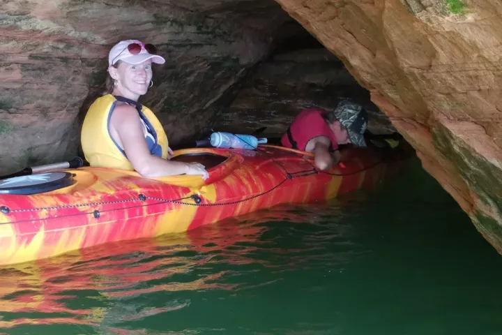 People in Tandem Kayaks going through tight passages in the caves at Meyers Beach