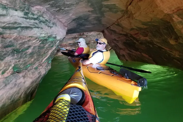 people in tandem kayaks going through very narrow passages in Meyers Beach Sea Cave