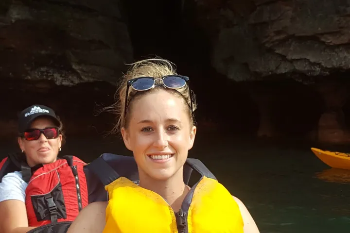 Two women in life vests kayaking