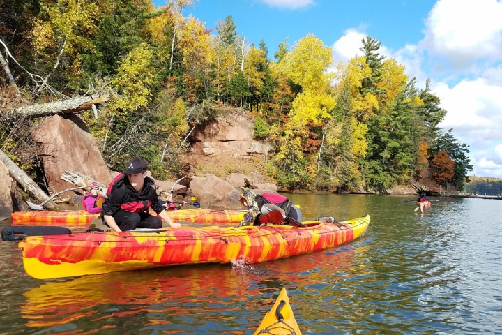 A group walking in their kayaks