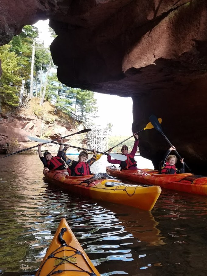 20171015_133455 Kayakers holding up their paddles at Red Cliff caves
